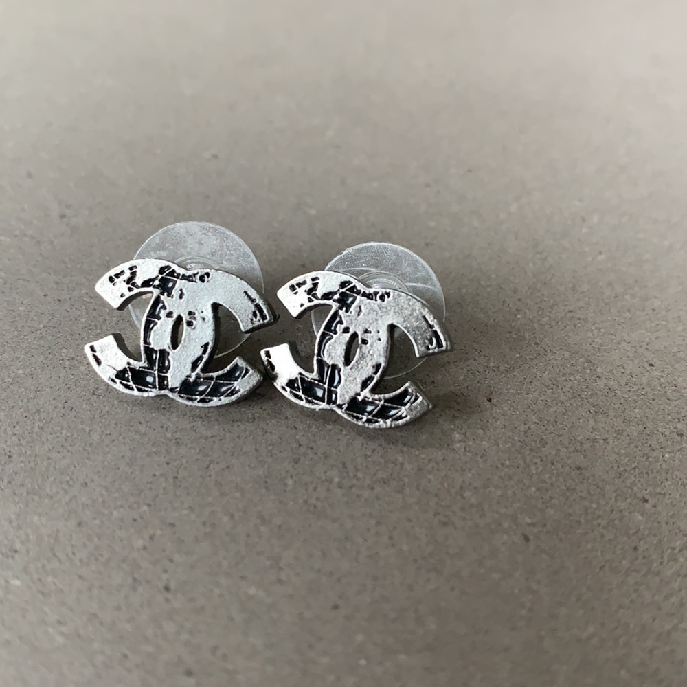Genuine Chanel silver “map/globe” CC earrings.